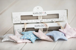 Soft pastel star-shaped nursery decor cushions in assorted patterns and colors