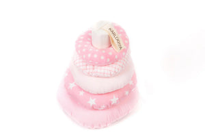 Pink fabric stacking toy with stars, stripes, polka dots, and soft rings for nursery