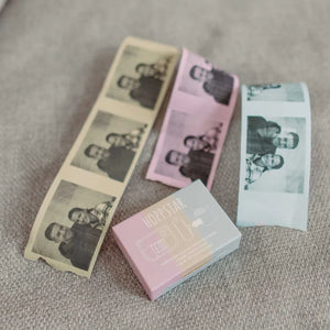 Hoppstar instant photo paper rolls in beige, pink, and white with printed family photos on textured fabric
