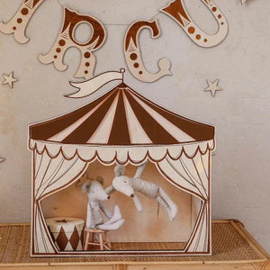 Wooden circus tent nursery decor with striped canopy, stuffed animals, and ABC wall letters