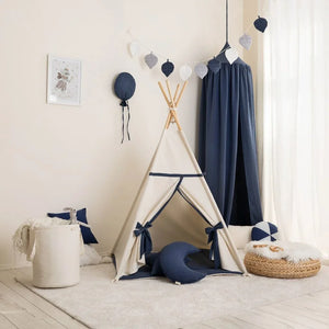 Beige and navy cotton teepee with crescent cushion and coordinating children’s room décor