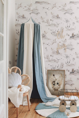 Blue Circus canopy styled with a rattan shell chair, toy trolley, wall art and matching floor mat