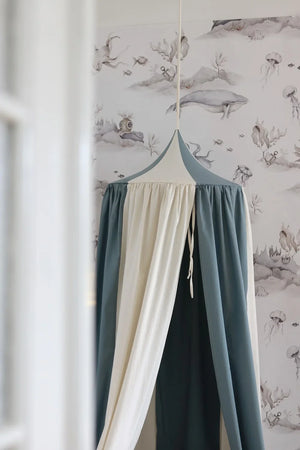 Close-up of the pointed Blue Circus canopy top and gathered blue and cream fabric panels
