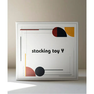 Stacking toy Y by Wooden Story, modern geometric design in red, black, yellow, and terracotta on white box