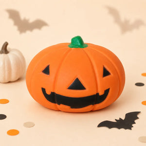 Orange 15 cm Halloween pumpkin squishy with black Jack-o’-lantern face, green stem and bat decorations