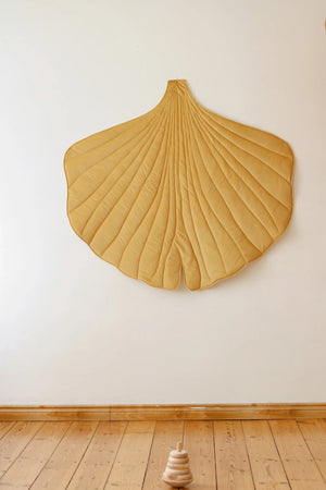 Honey Velvet Ginkgo Leaf Mat displayed as botanical wall décor above natural wooden flooring