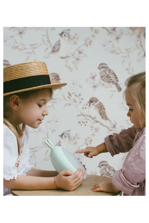 Enfants interagissant avec un réveil lumineux lapin bleu, décoration de chambre, papier peint à motifs oiseaux