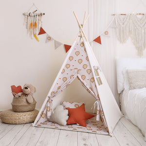 Lion-patterned cotton teepee tent styled with soft star and cloud cushions