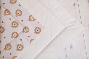 Close-up of the padded floor mat with lion print and cream border