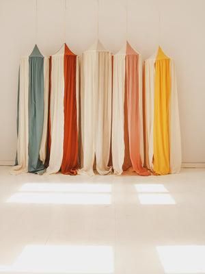 Five Moi Mili children’s canopies hanging together in a bright sunlit studio