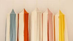 Blue Circus canopy displayed beside orange, cream, pink and yellow Moi Mili canopy colourways