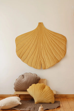 Honey Ginkgo Leaf Mat wall décor styled with neutral shell cushions and natural wood children’s furniture