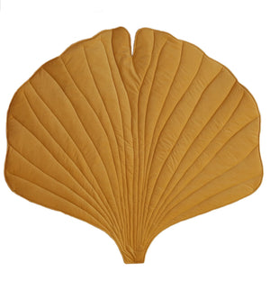 Front studio view of Moi Mili Honey Velvet Ginkgo Leaf Mat showing golden velvet surface and quilted botanical shape