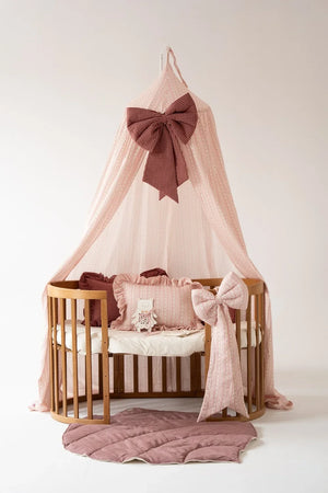 Vintage striped children’s canopy styled with ruffled cushions, decorative bow and dusty pink quilted play mat