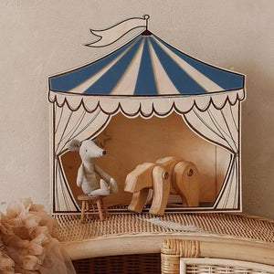 Wooden circus tent nursery decor with blue and cream stripes, featuring plush mouse and wooden horse inside