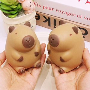 Two brown capybara squishy toys held in two hands