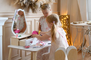 Children organising jewellery and accessories in drawers of white FAMILY Tulip Beauty Table