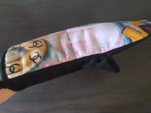 Colorful fabric oven mitt with black trim and artistic print design