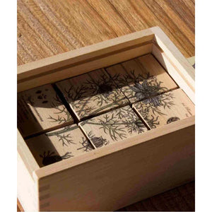 Wooden puzzle blocks with botanical flower prints in light wood box, natural finish