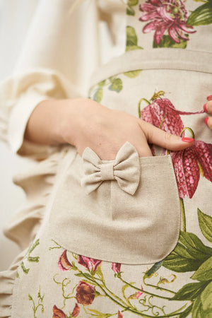 Floral print apron with beige bow pocket, cotton fabric, pink and green botanical design