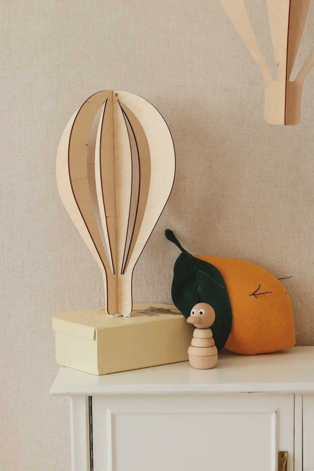 Set decorazioni da soffitto 3D a forma di mongolfiera in legno naturale, su una mensola della cameretta