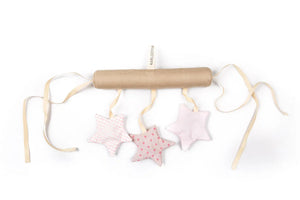 Handcrafted nursery mobile with soft fabric stars in pink patterns and beige hanging ties