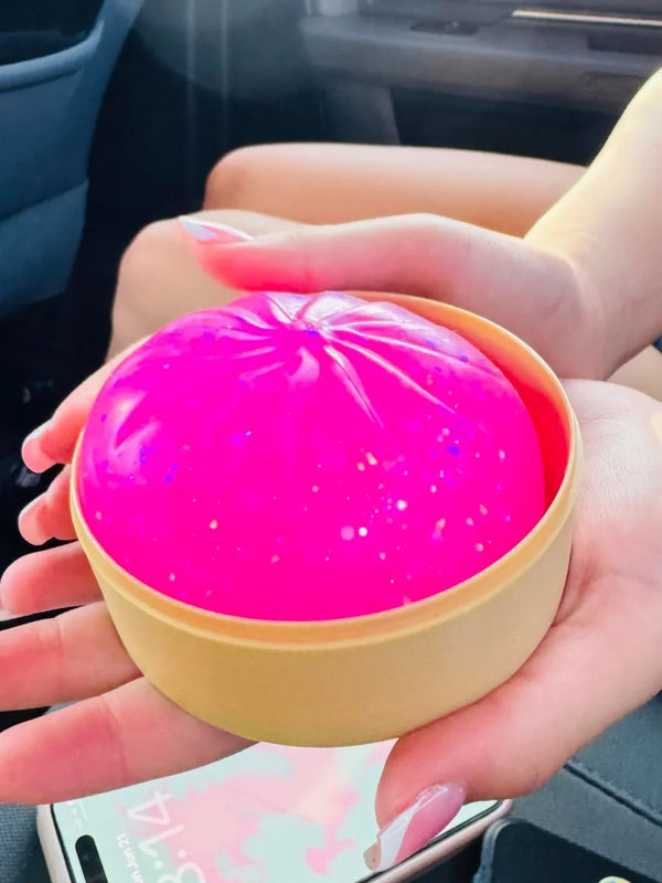 Child holding a colourful squishy toy from the Surprise Squishy Box