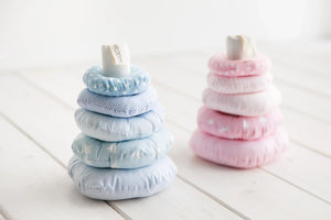 Soft fabric stacking toy with blue and pink pastel rings, baby nursery decor