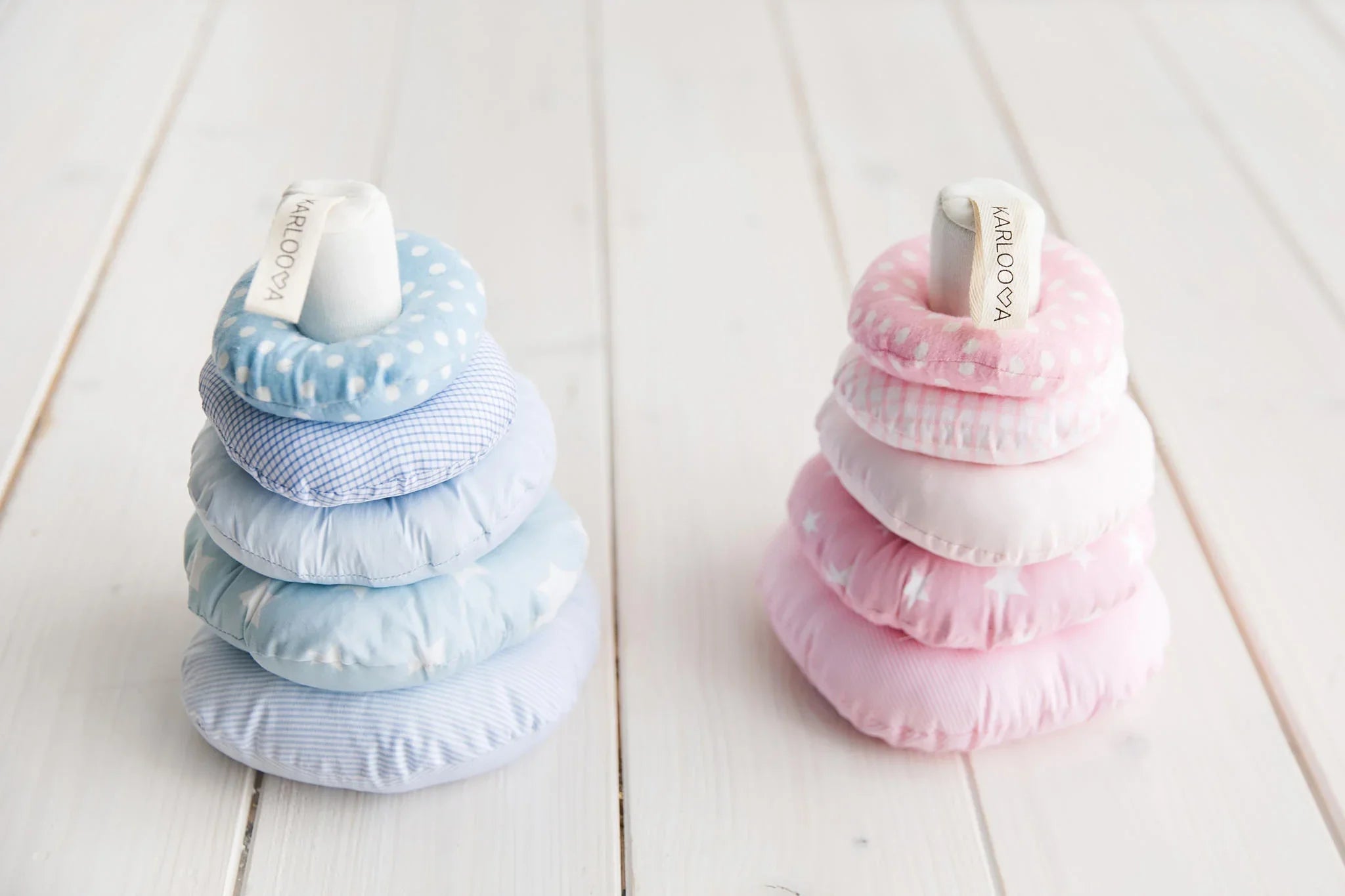 Plush stacking rings toy set in pastel blue and pink, soft fabric with polka dot and star patterns