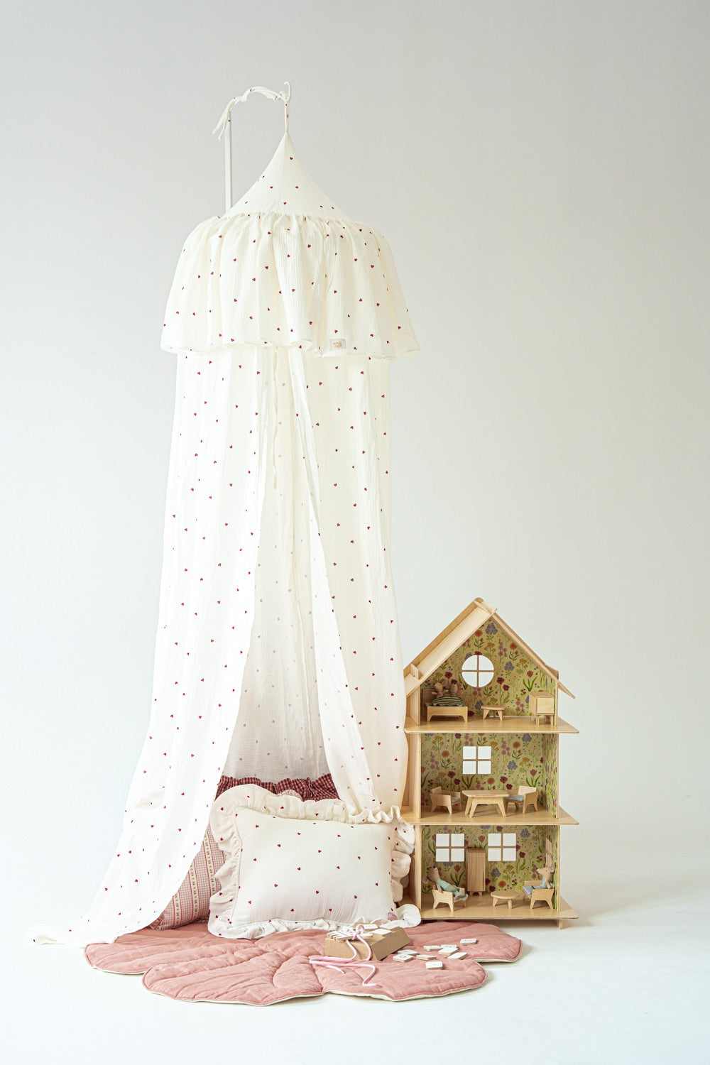 Moi Mili Sweet Hearts cotton canopy styled with pink flower play mats, heart cushions and a wooden dollhouse