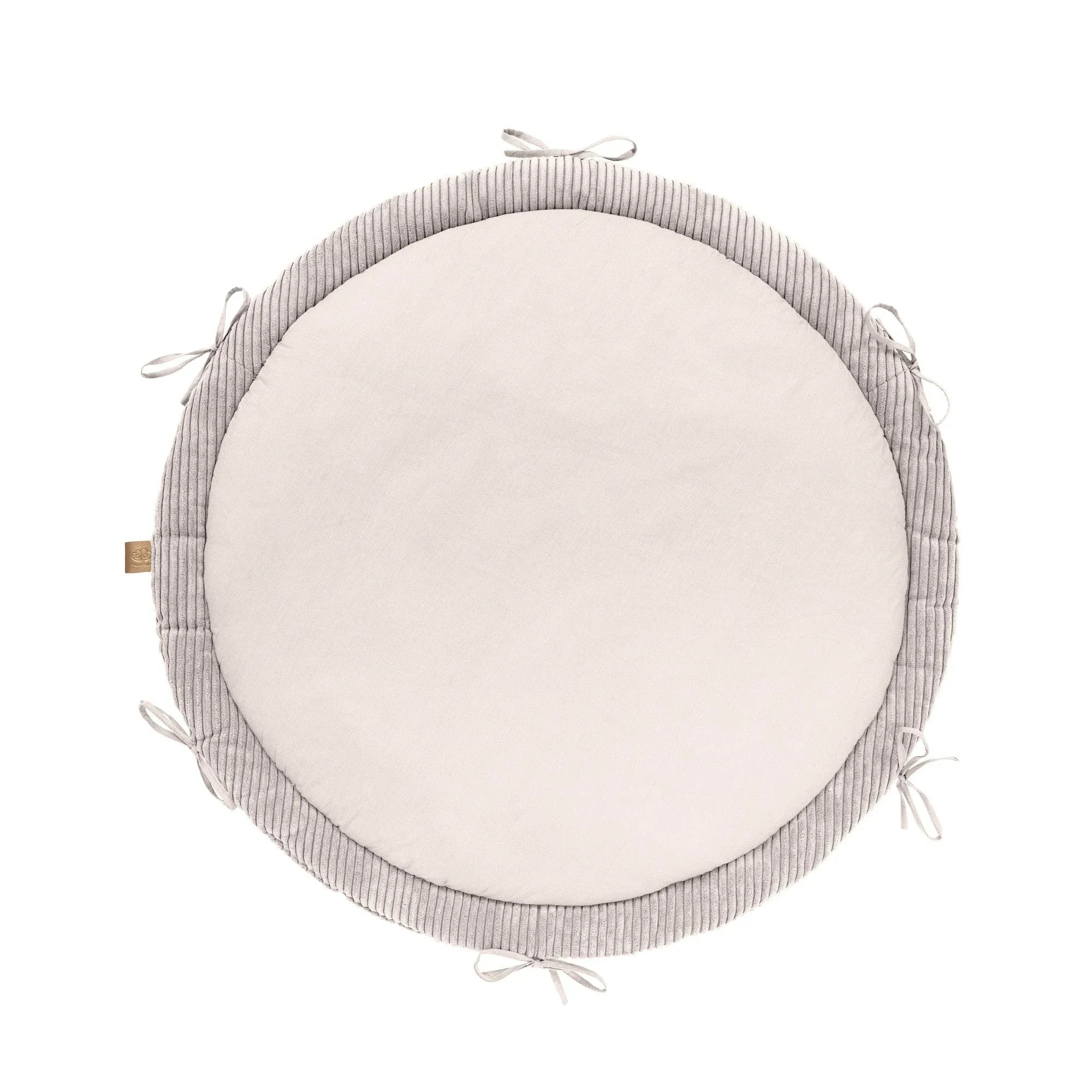 Round baby nest play mat in vanilla color with soft braided bumper and tie accents