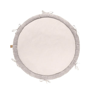 Round baby nest play mat in vanilla color with soft braided bumper and tie accents