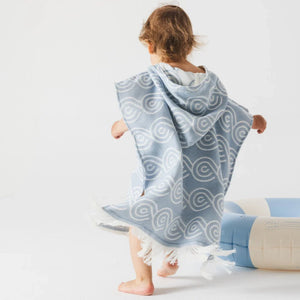 blue bamboo kids bath poncho with hood, wave pattern, and fringed hem
