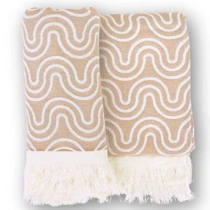 Sand-colored bamboo kids bath poncho with white wavy pattern and fringed edges