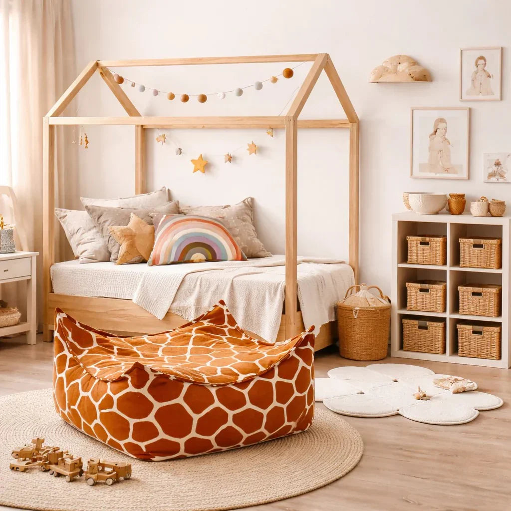 Square kids bean bag with orange and white giraffe print in cozy nursery room