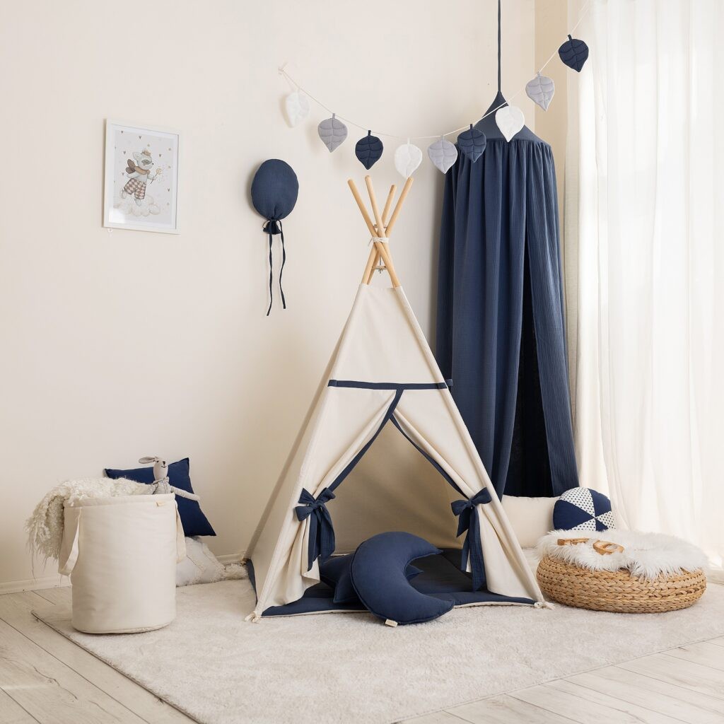 Beige and navy cotton teepee with crescent cushion and coordinating children’s room décor