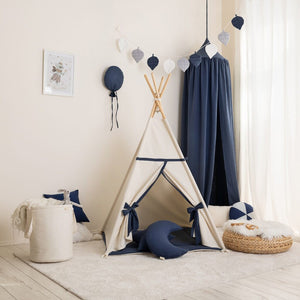 Beige and navy cotton teepee with crescent cushion and coordinating children’s room décor