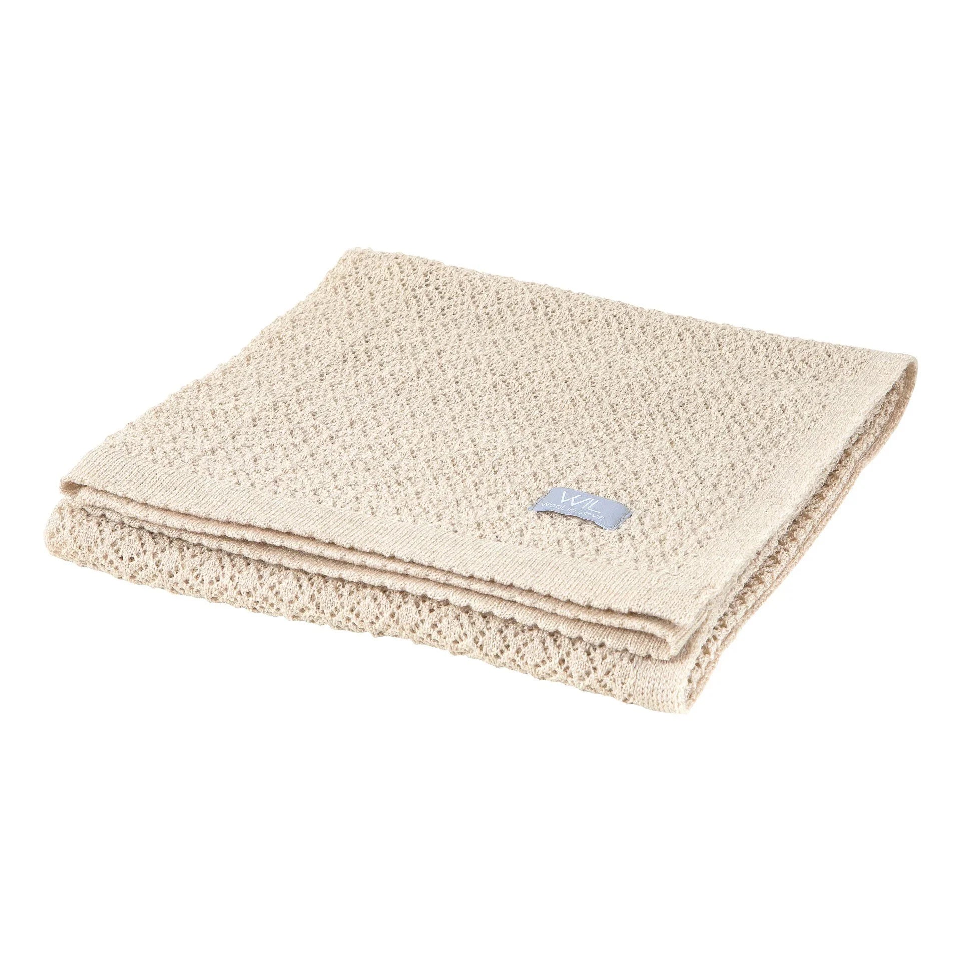 Couverture bébé en tricot texturé beige avec motif tissé doux et bords repliés