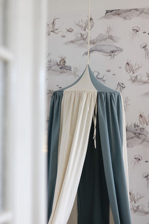 Close-up of the pointed Blue Circus canopy top and gathered blue and cream fabric panels
