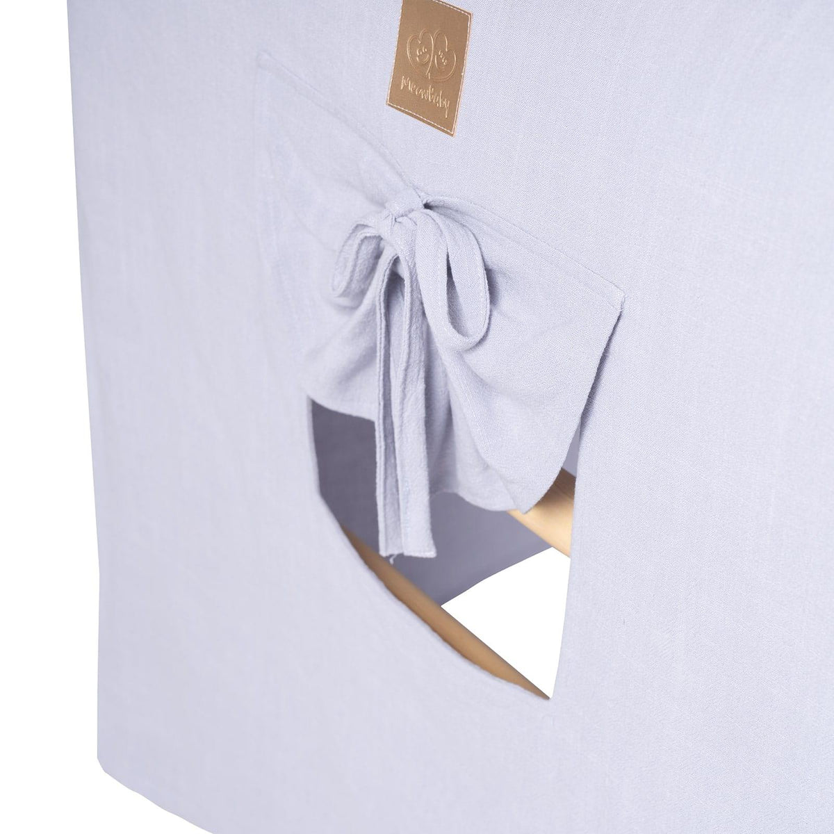 Close-up of blue-grey playhouse window with tie-back curtain and MeowBaby logo