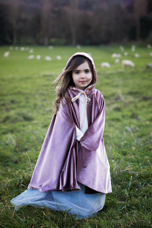 Child wearing the hooded Cosmic Pearl magic cape outdoors over a pale blue tulle costume