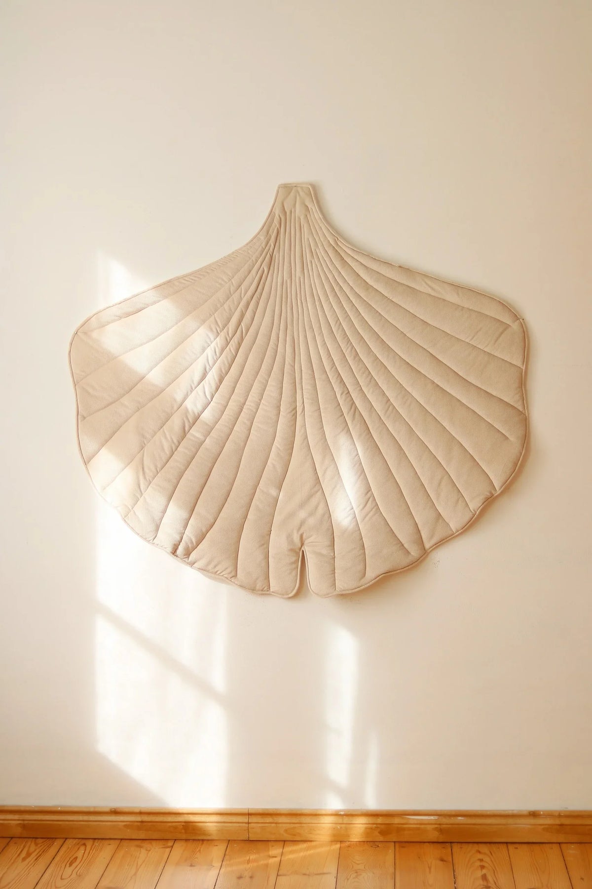 Cream Ginkgo Leaf Mat displayed as oversized textile wall décor in a warm neutral children’s room