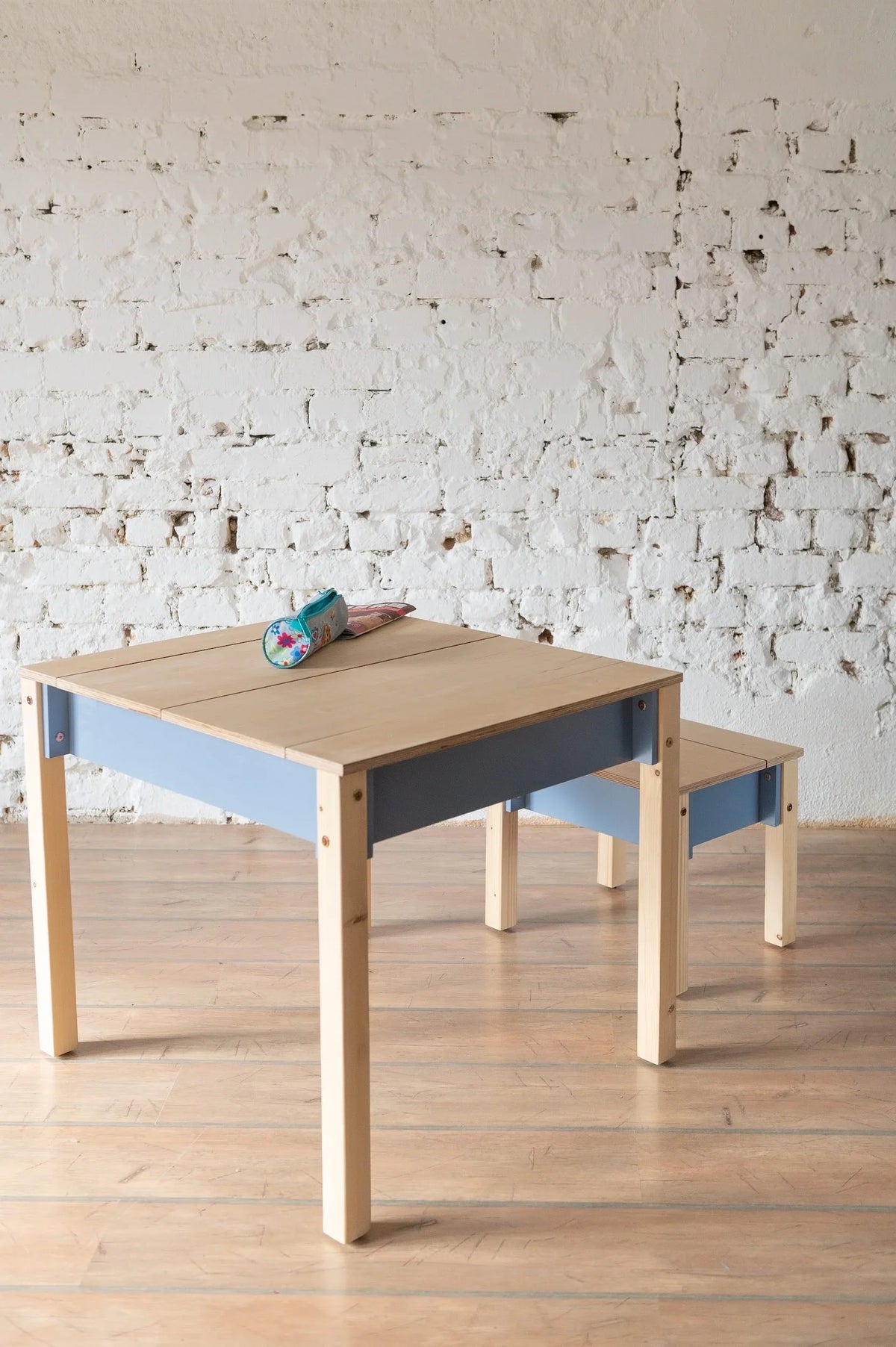 Dusty Blue children’s storage table and chair styled in a simple learning space