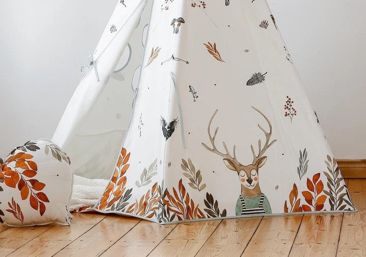 Close-up of the Forest Friends teepee with a friendly deer illustration among autumn leaves