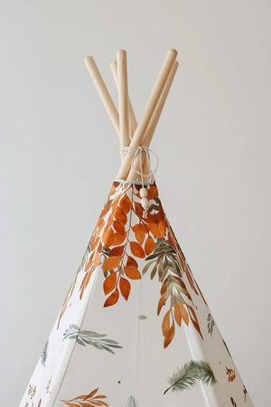 Close-up of natural pine teepee poles and orange woodland leaves on the Forest Friends fabric