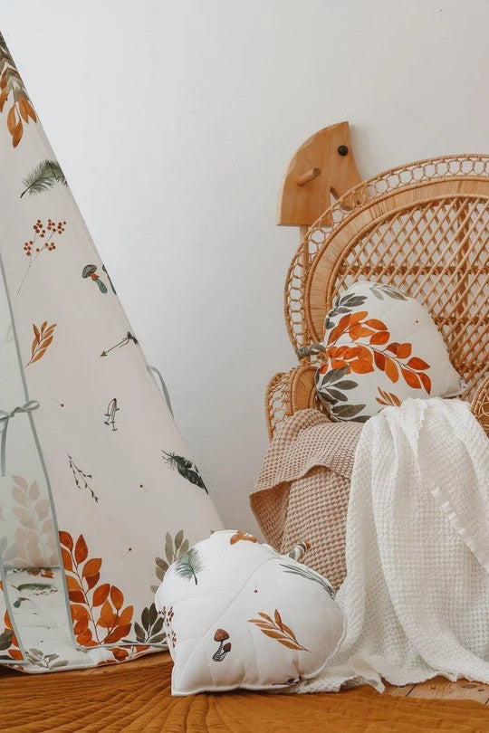 Woodland cushions styled beside the Forest Friends teepee on a rattan chair and quilted floor mat