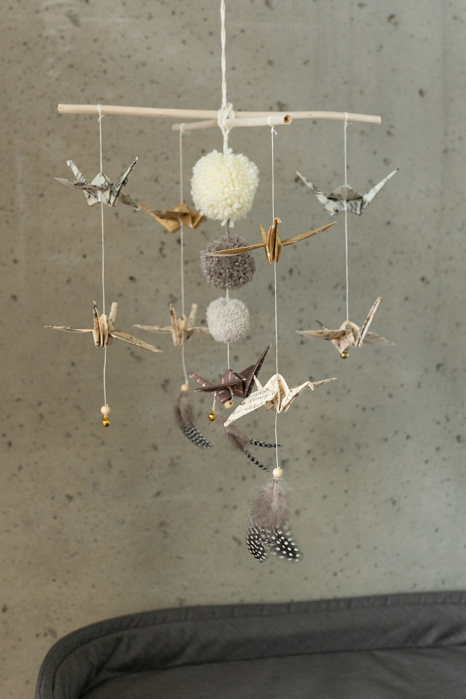 Full view of the Moi Mili Gold Dust mobile with paper birds, pompoms and feathers