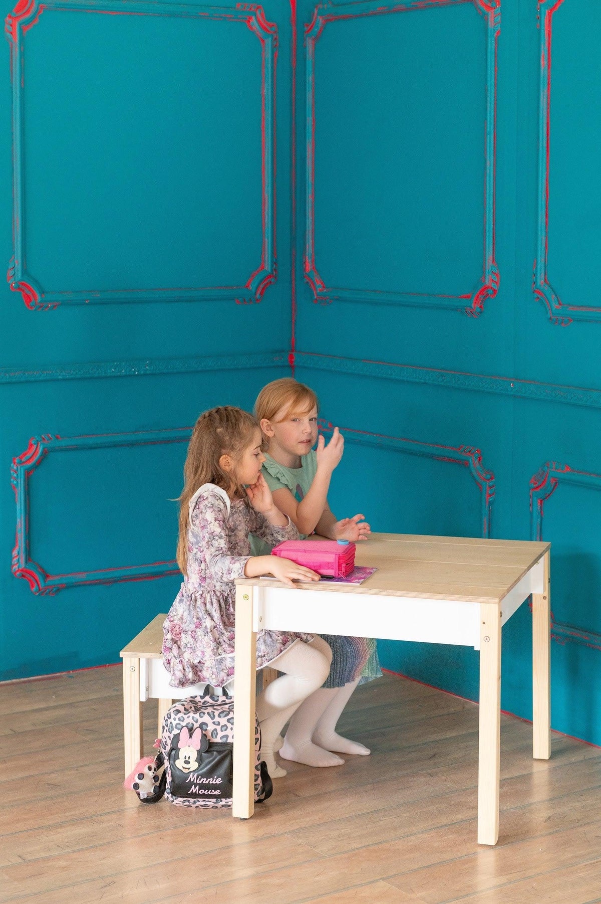Two children sitting at white FAMILY Smart Storage Table and Chair Set