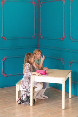 Two children sitting at white FAMILY Smart Storage Table and Chair Set