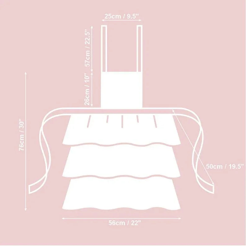 White tiered ruffled apron with measurements, 76cm tall, 56cm wide, for kitchen or nursery use